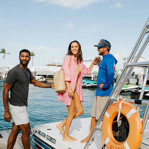 A group of people standing on a boat.