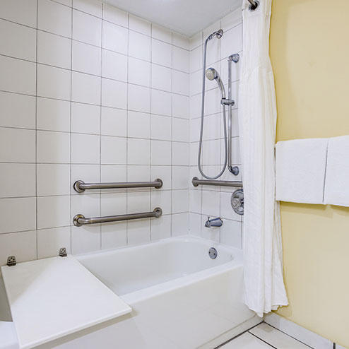 A bathroom with a tub and a shower.